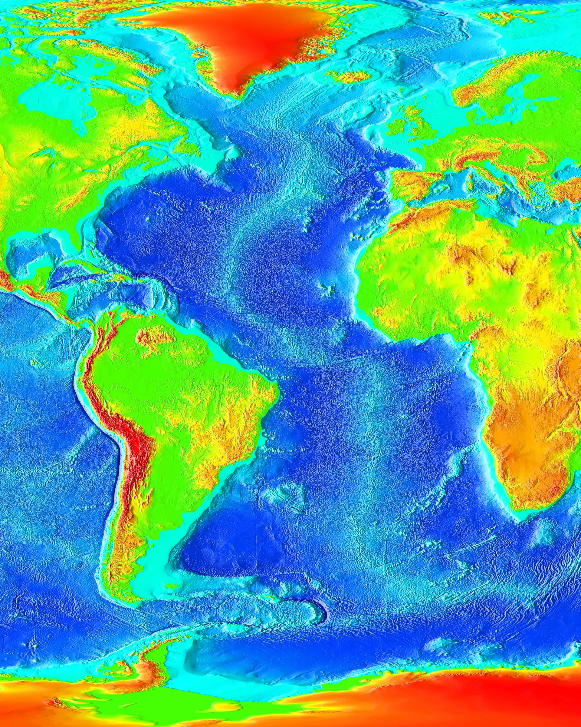 Bathymetric relief map of the Atlantic region. A long mid-ocean ridge runs down the center of the ocean basin, with broad abyssal plains, fracture zones, continental margins, trenches, and other large seafloor features visible around it.